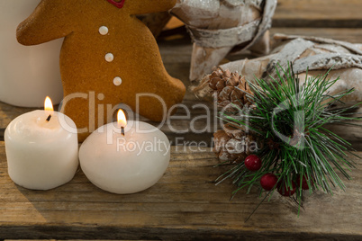 Close up of gingerbread cookie with star shape decorating and illuminated candles