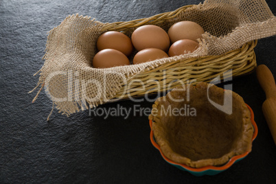 Eggs in wicker basket with dough