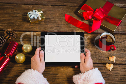 Santa Claus holding digital tablet