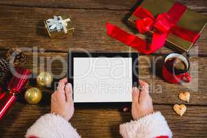 Santa Claus holding digital tablet