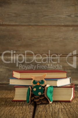 Book stack and christmas decoration on wooden plank