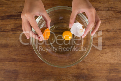 Man breaking eggs in bowl