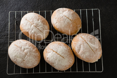 Dough balls with icing sugar on baking tray