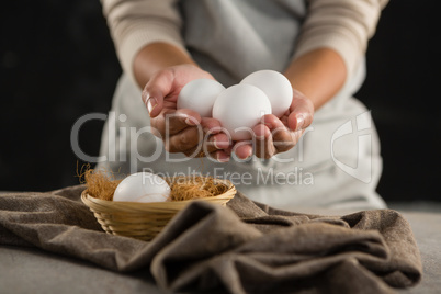 Woman holding white eggs