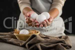 Woman holding white eggs