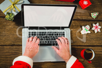 Santa Claus using laptop