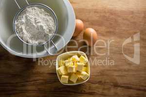 Flour in strainer with eggs and cheese