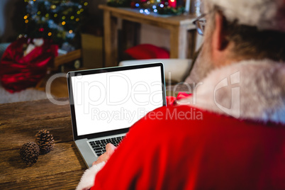 Santa Claus using laptop