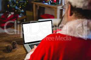 Santa Claus using laptop