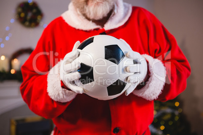 Santa claus holding a football