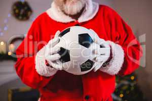 Santa claus holding a football