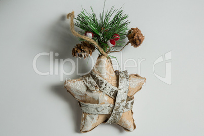 Close up of star shape decoration with pine cone and twig