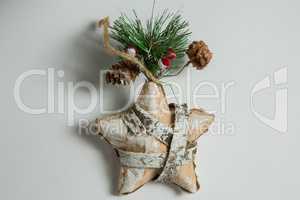 Close up of star shape decoration with pine cone and twig