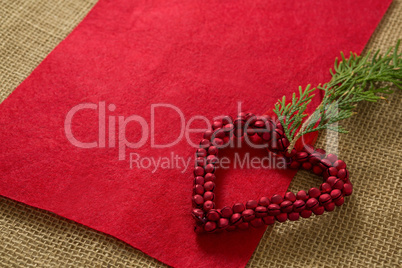 Jingle bells in heart shape decoration with pine twig