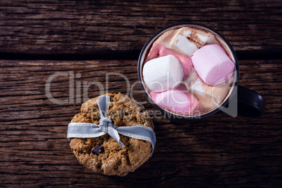 Cookies and hot chocolate on wooden plank