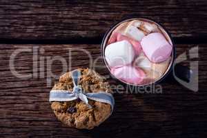 Cookies and hot chocolate on wooden plank