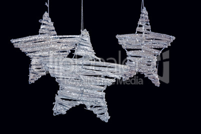 Handmade stars hanging against black background