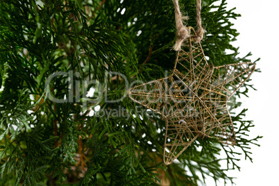 Star shape christmas decoration hanging on christmas tree