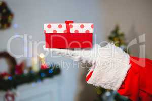 Santa claus holding a gift box