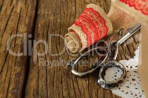 Ribbon and scissors on wooden plank