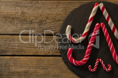 Candy canes arranged on wood