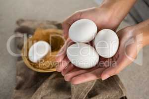 Woman holding white eggs