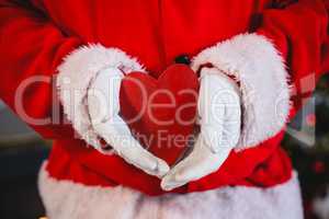 Santa claus holding a heart