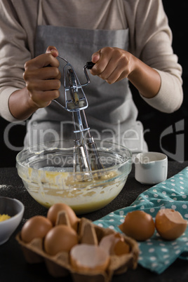 Woman whisking batter in a bowl