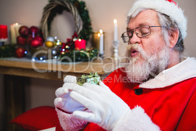 Santa claus holding a gift