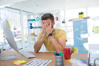 Depressed male executive working on computer