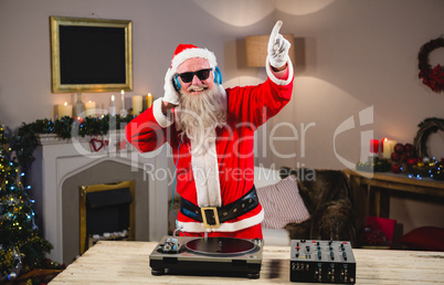 Santa claus playing a dj