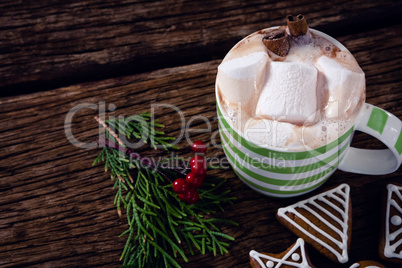 Cookies, mistletoe and hot chocolate on wooden plank