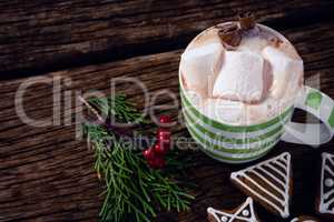 Cookies, mistletoe and hot chocolate on wooden plank