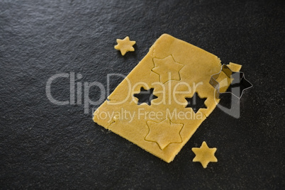 Raw cookie dough with star shaped cookie cutter