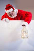 Santa Claus holding christmas lantern on white board