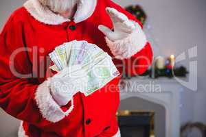 Santa claus holding a bundle of euros
