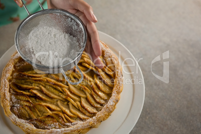 Woman icing on apple tart