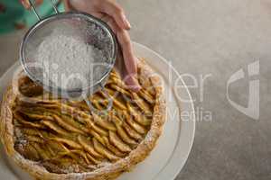 Woman icing on apple tart