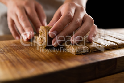 Woman arranging dough on chopping board