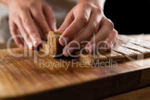 Woman arranging dough on chopping board