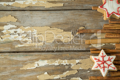 Christmas cookies and cinnamon wooden plank