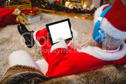Santa claus using digital tablet at home