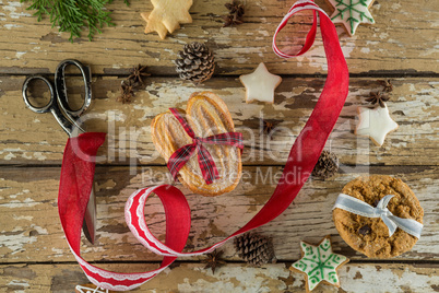 Gingerbread cookies and christmas decoration on wooden plank