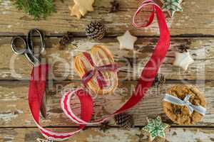 Gingerbread cookies and christmas decoration on wooden plank