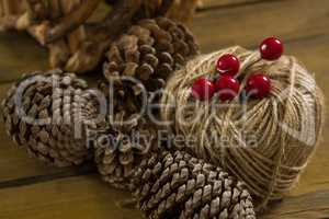 High angle view of pine cones with thread spool with push pin