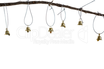 Christmas bells hanging on branch