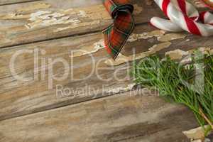 Sweet food and christmas decorations on wooden plank