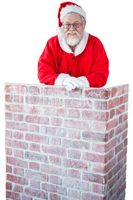 Santa claus leaning on the chimney against white background