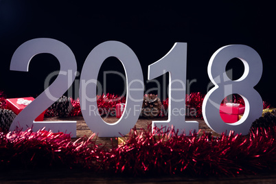 Numbers surrounded with christmas decoration on wooden plank