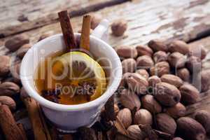 Tea, spices and nuts on wooden plank